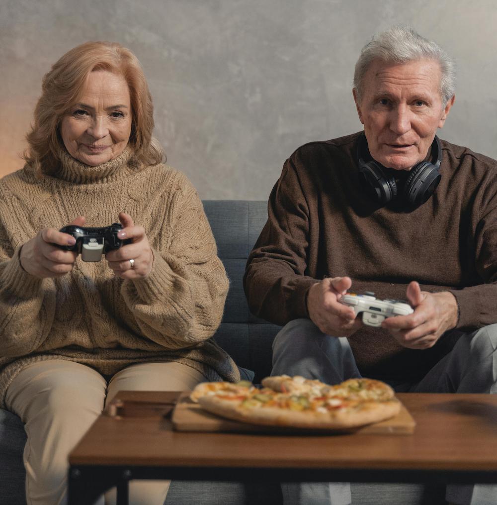 elderly couple playing video games